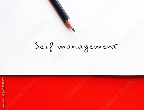 Fotografie White paper on red background  with pencil handwritting SELF MANAGEMENT, ability