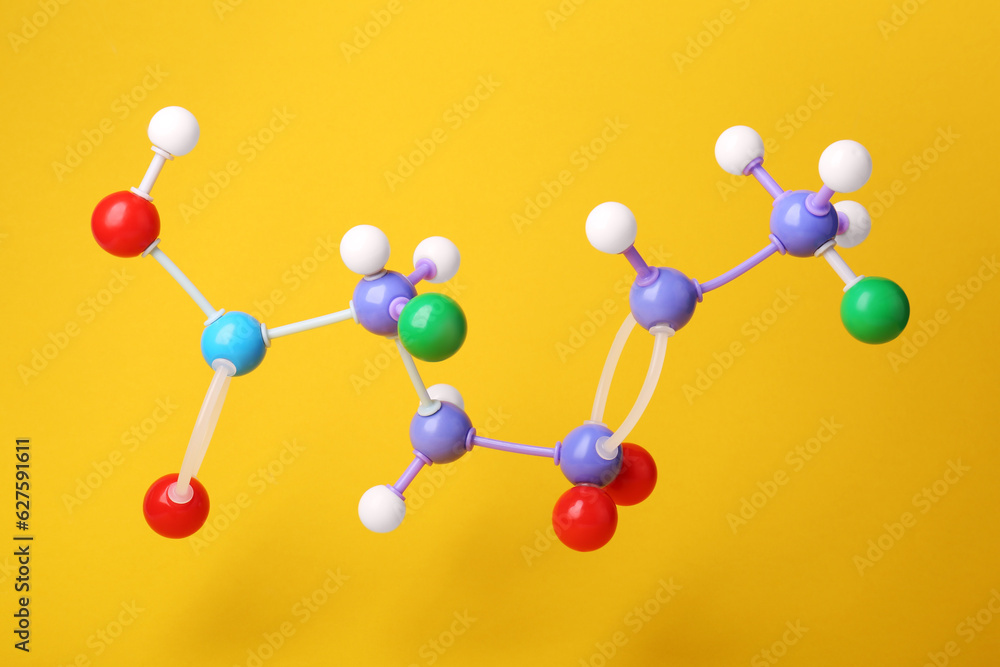 Obraz premium Structure of molecule on yellow background. Chemical model
