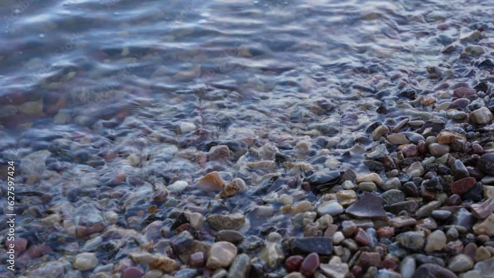 Close up of water washing against pebbles Close up of water washing against pebbles