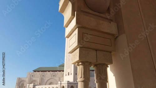 Passing decorative Moroccan archway to views of majestic Hussan ii mosque marble architecture landmark photo