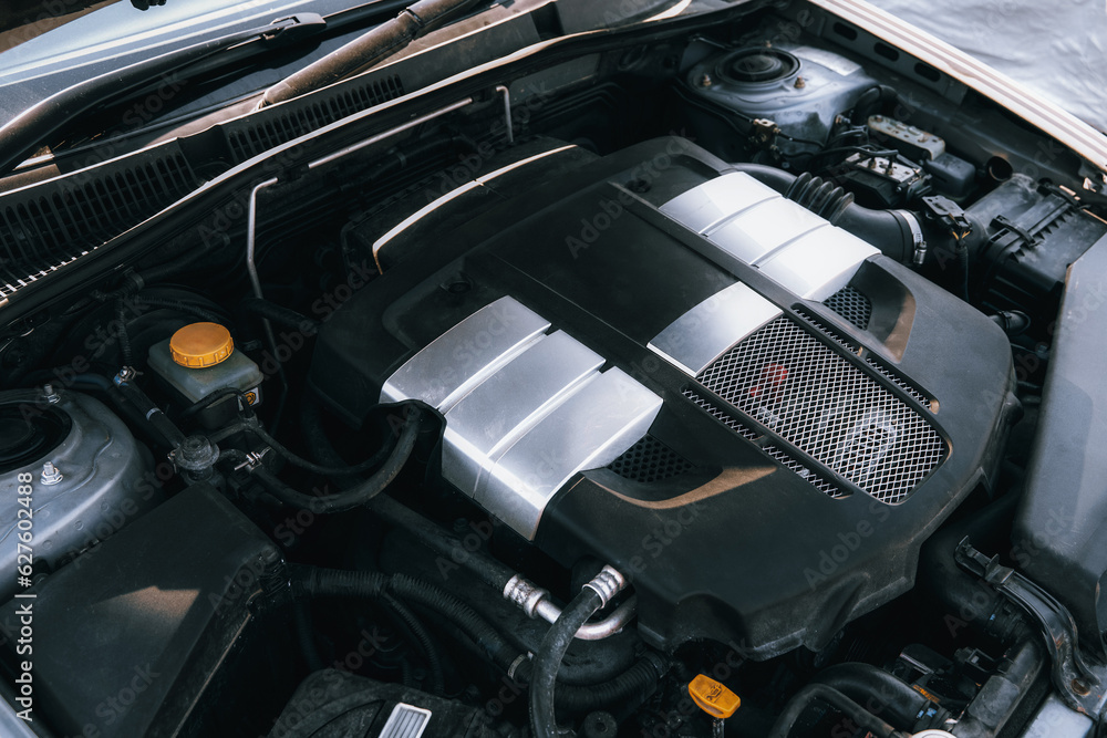A Closeup of the Horizontally Opposed 6-Cylinder Boxer Engine Under the Hood - Revealing the Clean and Powerful Motor Block of a Sports Car. The engine under the hood.
