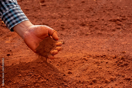 Dirty hands holding dry soil reveal the hard work and dedication of a gardener tending to the land, Agriculture, Organic gardening, Planting or ecology concept, Environmental, Copy space.