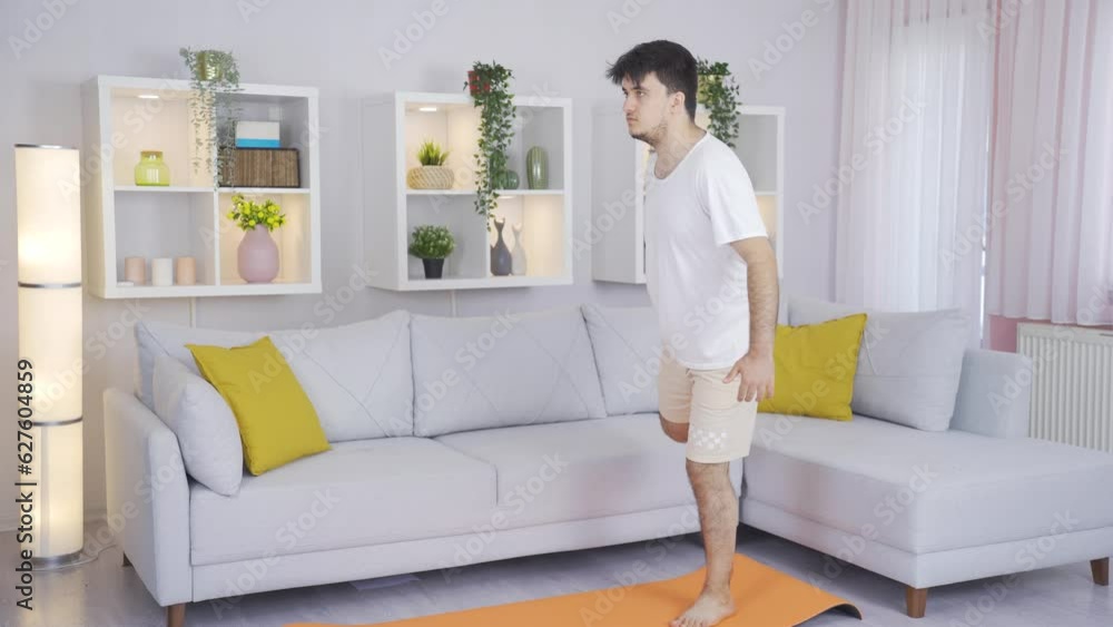 Man exercising at home. Leg stretching. Man exercising at home. Leg stretching.
