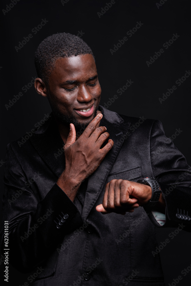 Smiling black man looking at wristwatch Smiling black man looking at wristwatch