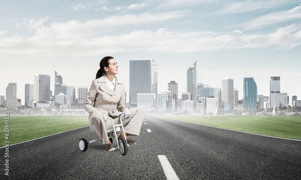 Beautiful young woman riding children's bicycle Beautiful young woman riding children's bicycle