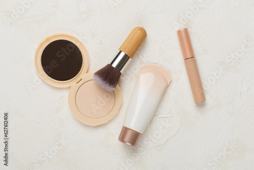 Composition with makeup products for skin tone on concrete background, top view