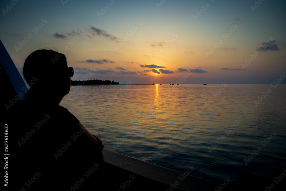 Woman on a Liveaboard watching Sunset