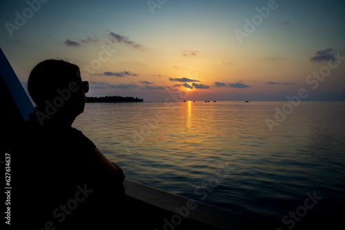 Woman on a Liveaboard watching Sunset © feel4nature