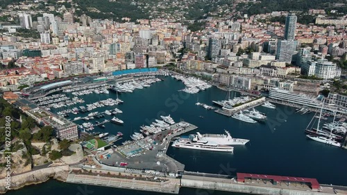 Panoramic view of La Condamine ward and Port Hercules in Monaco-Ville, Cote d'Azur ft. World Fair MYS Monaco Yacht Show in Monte Carlo with luxury yachts and boats are in marina, Mediterranean Sea 4K photo