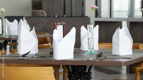 Table napkin and dining set at the restaurant. Food and beverage business concept.