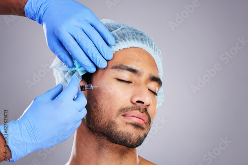 Hands, aesthetic and plastic surgery with a man in studio on a gray background for silicon injection. Facial, beauty or transformation with a male customer in a clinic for antiaging filler or implant