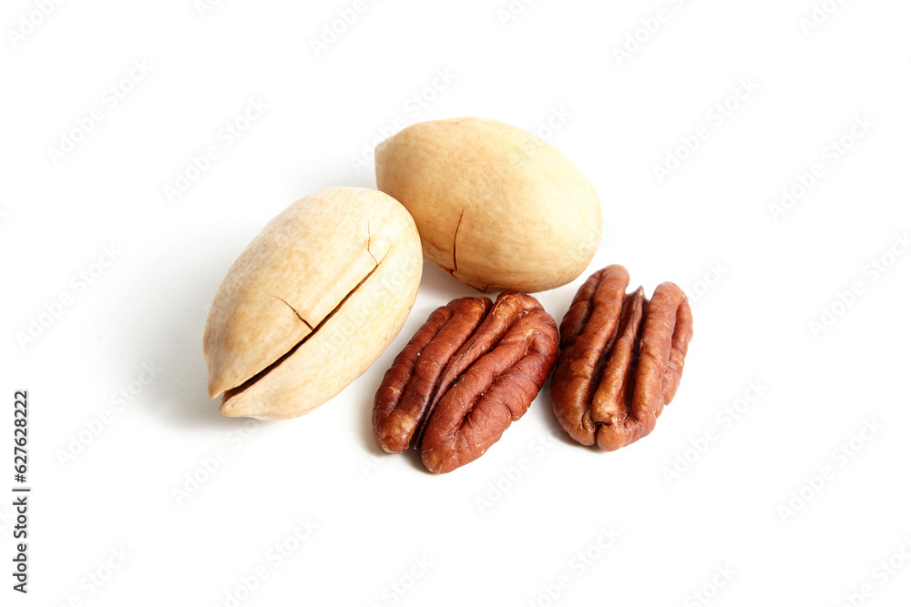 Pecan nuts in shell and peeled pecan halves isolated on white background. Two whole and two halves of pecan nuts Pecan nuts in shell and peeled pecan halves isolated on white background. Two whole and two halves of pecan nuts