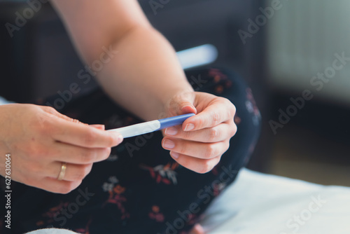pregnancy test in woman hand close up