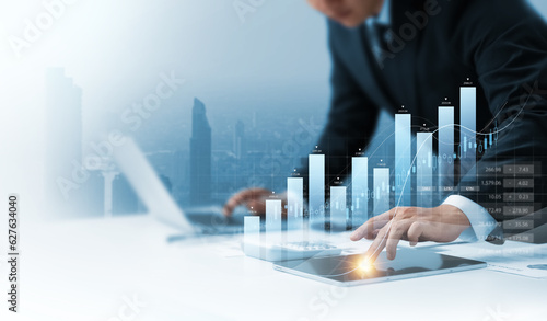 Photo Businessman using tablet analyzing business growth graph data and progress, compass of navigate guiding market direction