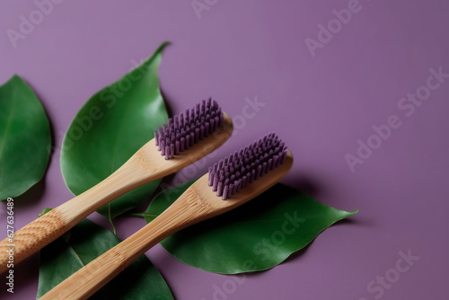 Generative AI. Bamboo Toothbrush On A purple Background. Zero waste lifestyle. plastic free products. Natural organic bathroom beauty product concept