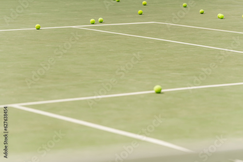 nobody on shot, tennis balls on spacious court, blurred foreground, summer, sport and leisure