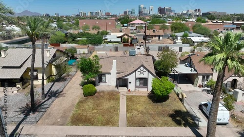 House in city suburb of Phoenix, AZ. Aerial establishing shot of Arizona housing neighborhood outside of large urban area.