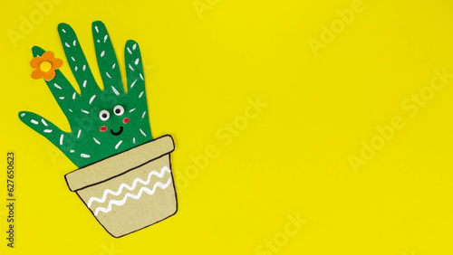 cardboard cactus on yellow background. children's crafts from palm