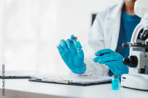 African American female technician testing blood sample in lap. blood test is one of the most common tests healthcare provider uses to monitor your overall health or help diagnose medical condition.