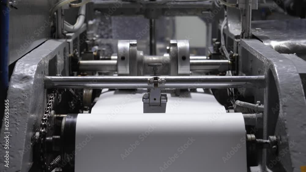 Wrapping paper tape in roll on conveyor. Spinning labels for packaging