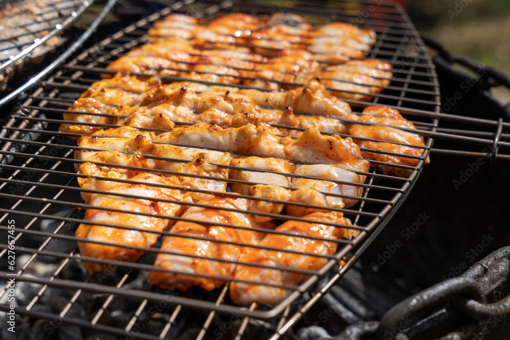 Grill with chicken being grilled