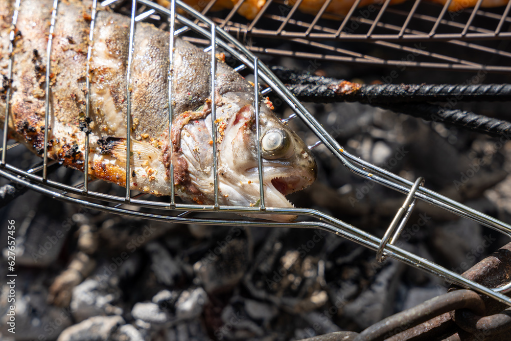 Close up of fish head being grilled on grill