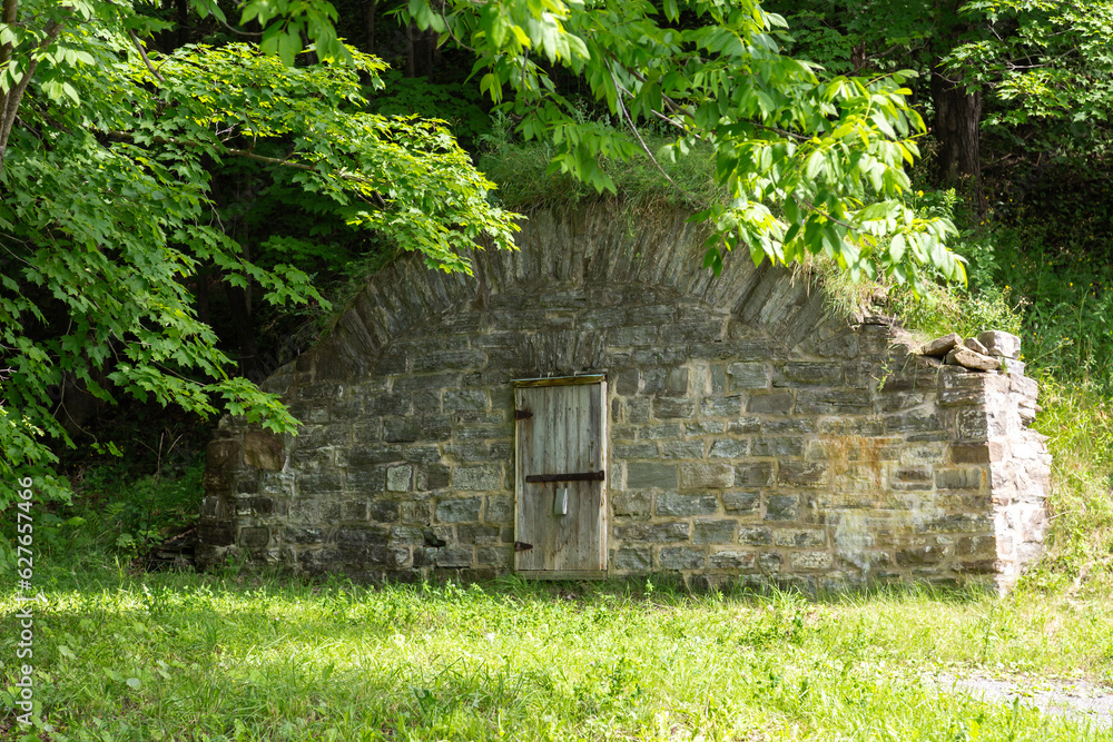 Large old 19th Century stone root cellar with arched top seen on Avenue Royale in summer, Château-Richer, Beaupré Coast, Quebec, Canada Large old 19th Century stone root cellar with arched top seen on Avenue Royale in summer, Château-Richer, Beaupré Coast, Quebec, Canada