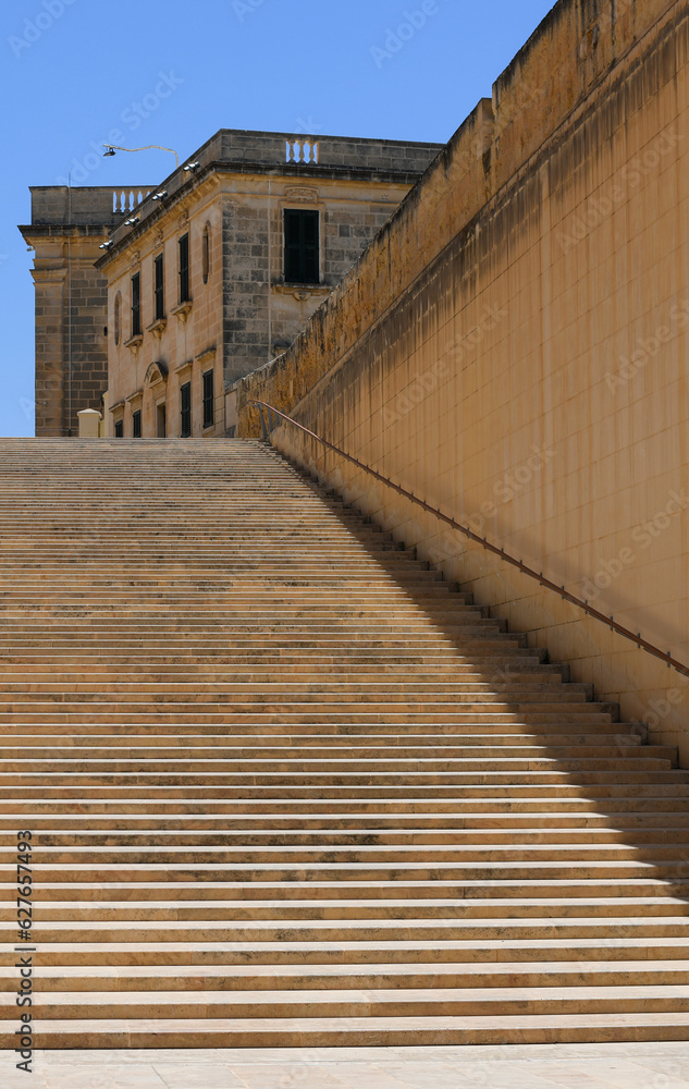 Long stairs from yellow stone near to Valletta City Gate in Malta 