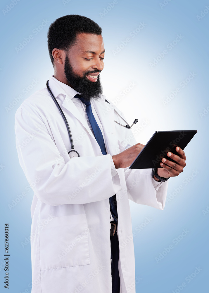 Medical, tablet and a black man doctor in studio on a blue background for cardiology research. Healthcare, technology and innovation with a male medicine professional searching for information online Medical, tablet and a black man doctor in studio on a blue background for cardiology research. Healthcare, technology and innovation with a male medicine professional searching for information online