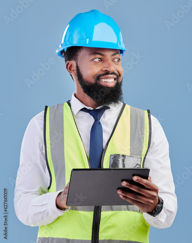 Happy black man, architect and tablet for construction inspection against a blue studio background. African male person, engineer or contractor working on technology for architecture or project plan
