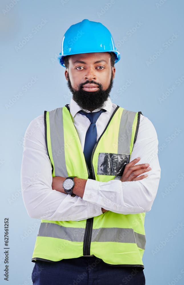 Engineering, man or serious portrait with arms crossed in studio in development, building construction or industrial technician. Black male architect, contractor or project manager on blue background Engineering, man or serious portrait with arms crossed in studio in development, building construction or industrial technician. Black male architect, contractor or project manager on blue background