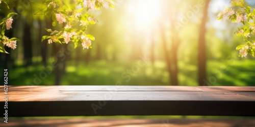 Spring summer beautiful nature background with blurred park trees in sunlight and empty wooden table