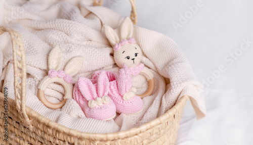 Cute wooden and knitted baby toys on light background. Eco accessories and teethers for newborns. 