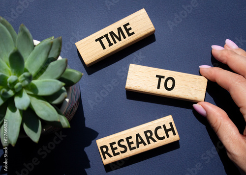 Time to Research symbol. Concept word Time to Research on wooden blocks. Businessman hand. Beautiful deep blue background. Business and Time to Research concept. Copy space