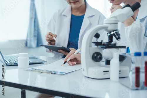 Health care researchers working in life science laboratory, Teaching in labs - Requiring students to record their laboratory methods and results as a running record of their laboratory work.