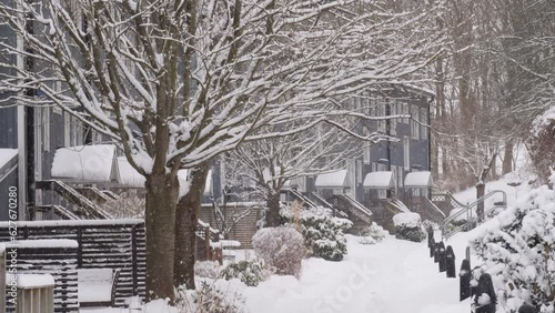 Street with Attached Wooden Houses and Soft Snow Falling, Winter Holiday scene