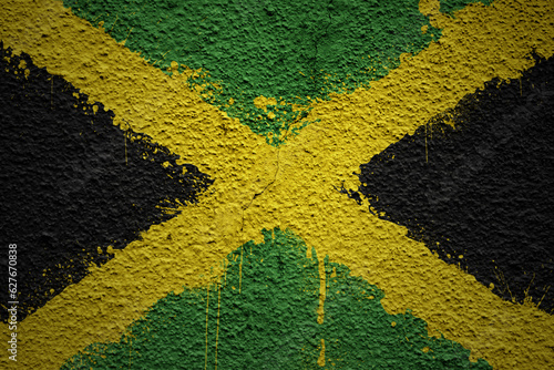 painted big national flag of jamaica on a massive old cracked wall