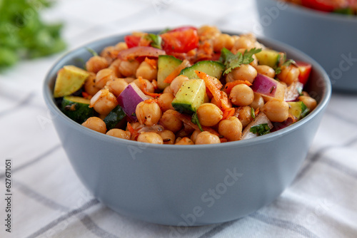 Homemade Avocado Chickpea Salad with Chili Lime Dressing in a Bowl, side view. Close-up.