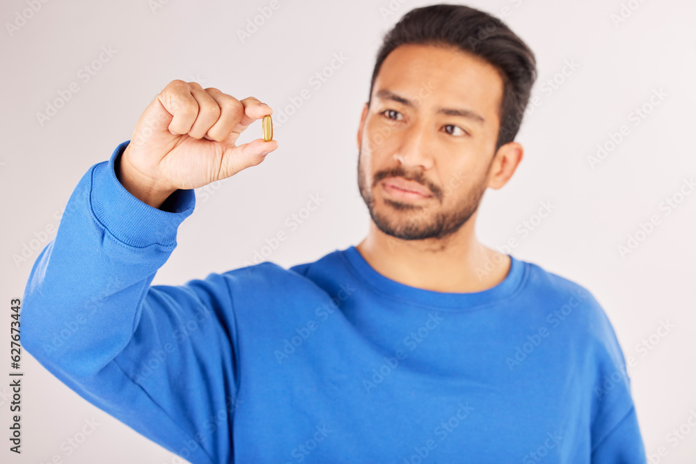 Healthcare, showing and a man with a pill on a studio background for a virus, covid or supplement. Sick, medical and an Asian person with a tablet, medication or vitamin c medicine for wellness Healthcare, showing and a man with a pill on a studio background for a virus, covid or supplement. Sick, medical and an Asian person with a tablet, medication or vitamin c medicine for wellness