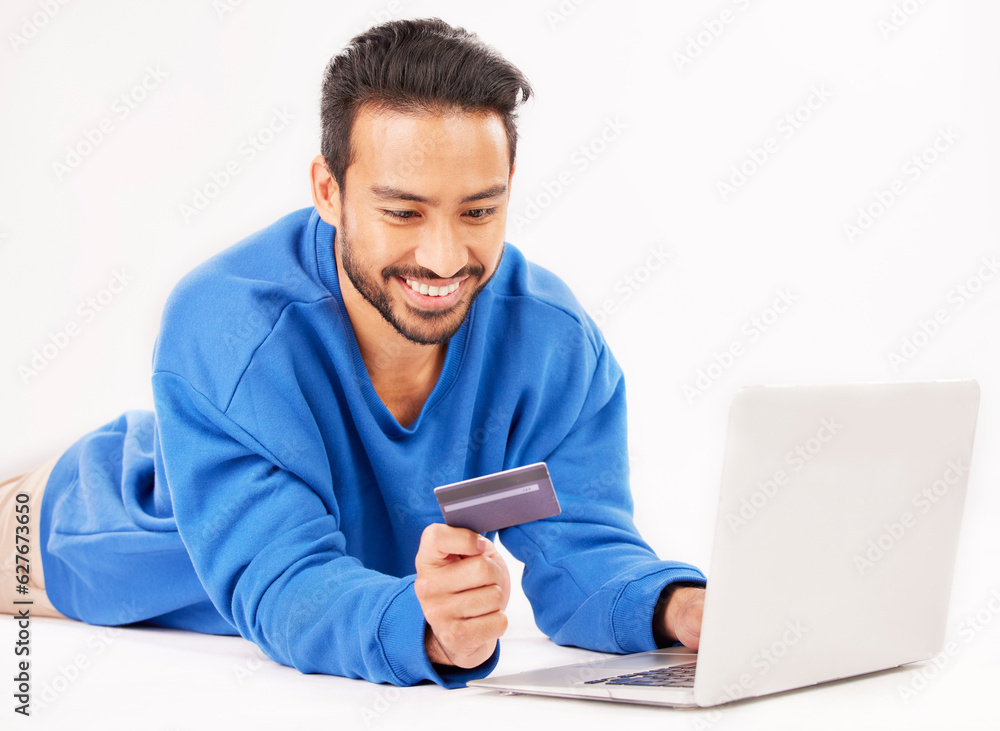 Studio laptop, credit card and happy man online shopping for tech discount, promotion or e commerce sales. Customer payment, trading store and relax financial banking person on white background floor Studio laptop, credit card and happy man online shopping for tech discount, promotion or e commerce sales. Customer payment, trading store and relax financial banking person on white background floor