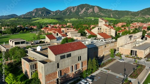 University of Colorado Boulder aerial establishing shot. Beautiful red roofs and mountains in background. photo