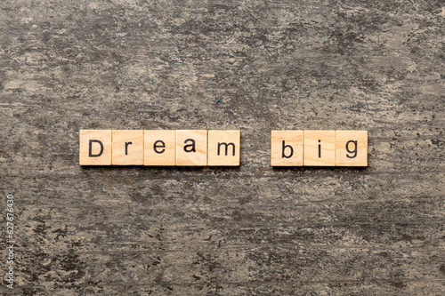 Dream big word written on wood block. Dream big text on cement table for your desing, Top view concept