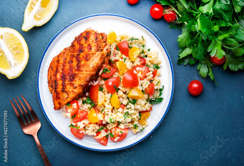 Fototapete Grilled chicken with bulgur tabbouleh salad with tomatoes, parsley and olive oil