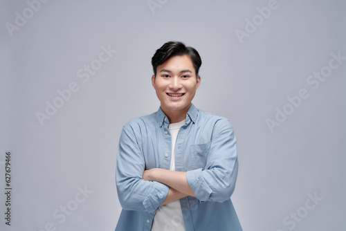 Handsome portrait of young Asian man smiling isolated on white background