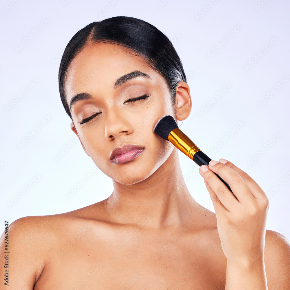 Makeup brush, beauty and cosmetics of a happy woman in studio for skincare, self care and cosmetology. Skin glow, shine and wellness of a female model with facial application tools for foundation