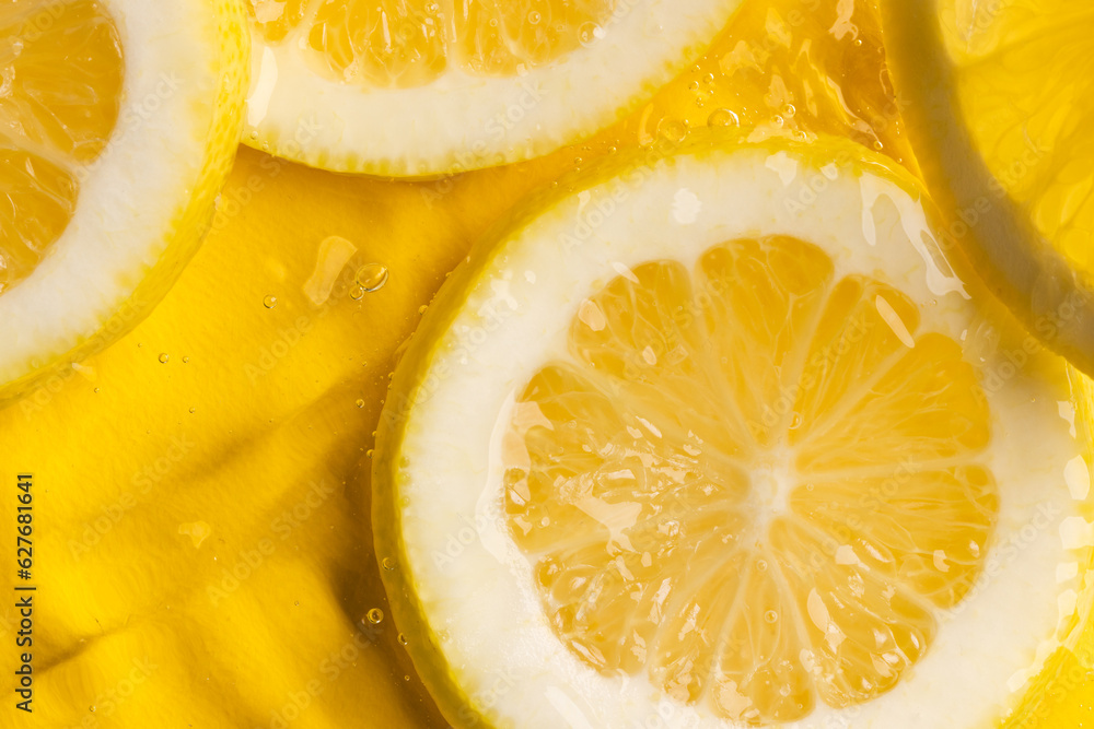 Close up of lemon slices in water with copy space on yellow background Close up of lemon slices in water with copy space on yellow background