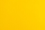 Vibrant bright yellow background with rippled texture and copy space
