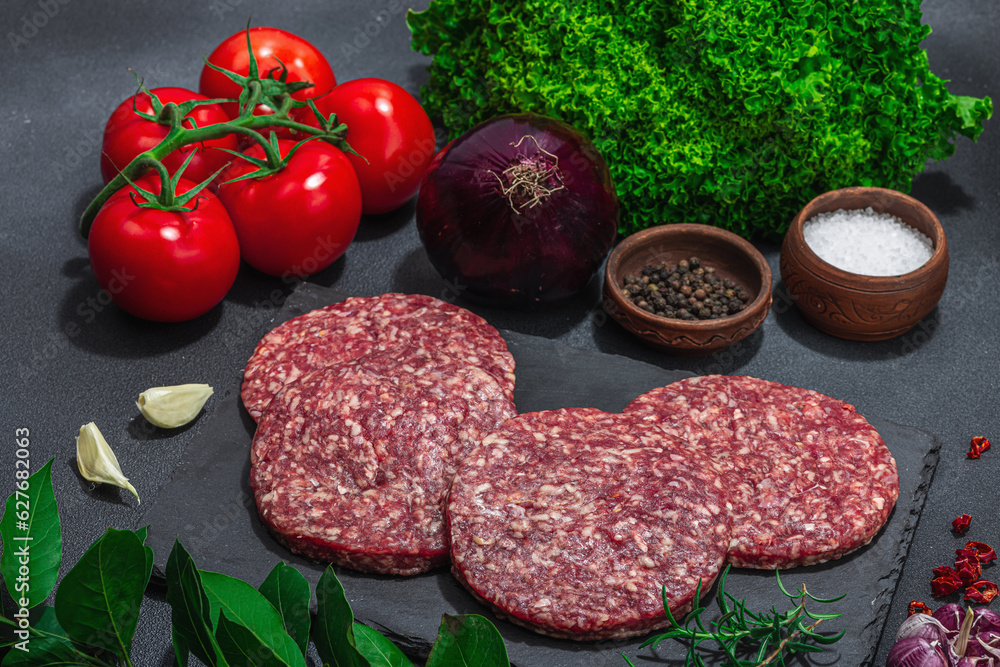 Raw burger patties. Fresh meat cutlets, spices, vegetables, herbs. Homemade American classic Raw burger patties. Fresh meat cutlets, spices, vegetables, herbs. Homemade American classic