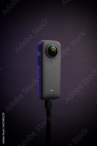 Modern 360 degree digital camera on black background