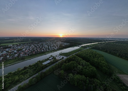 Sunset over a town with a river